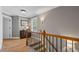 Upstairs hallway with hardwood floors, neutral walls, and natural light at 1251 Brickton Nw Dr, Atlanta, GA 30318