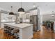Modern kitchen features a large island with seating, stainless steel appliances, and pendant lighting at 1251 Brickton Nw Dr, Atlanta, GA 30318