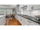 Well-lit kitchen with white cabinets, dark countertops, stainless steel appliances, and hardwood floors at 1251 Brickton Nw Dr, Atlanta, GA 30318