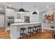 Bright kitchen features stainless steel appliances, white cabinets, a large island with seating, and hardwood floors at 1251 Brickton Nw Dr, Atlanta, GA 30318