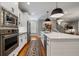 Modern kitchen with stainless steel appliances, white cabinets, a large island with seating, and hardwood floors at 1251 Brickton Nw Dr, Atlanta, GA 30318