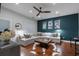 Living room with wood floors, a ceiling fan, and a large neutral couch at 1251 Brickton Nw Dr, Atlanta, GA 30318