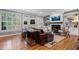 Bright living room featuring a fireplace, hardwood floors, and plantation shutters at 1251 Brickton Nw Dr, Atlanta, GA 30318