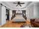 Large main bedroom with hardwood floors, a tray ceiling, and a sitting area at 1251 Brickton Nw Dr, Atlanta, GA 30318