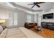 Comfortable main bedroom with wood floors, tray ceiling, ceiling fan, and an accent couch at 1251 Brickton Nw Dr, Atlanta, GA 30318