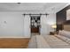 Modern main bedroom looking at en-suite bathroom through sliding barn doors at 1251 Brickton Nw Dr, Atlanta, GA 30318