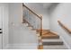 Staircase featuring white risers, wood handrail, and wrought iron balusters at 1251 Brickton Nw Dr, Atlanta, GA 30318
