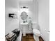 Well-lit half bathroom features a pedestal sink, toilet, and elegant fixtures at 3535 Fairgreen Ct, Douglasville, GA 30135