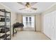 Neutral bedroom features a ceiling fan, large window and closet at 3535 Fairgreen Ct, Douglasville, GA 30135