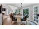 Bright dining area featuring vaulted ceilings, a large window overlooking the lush yard, and hardwood floors at 3535 Fairgreen Ct, Douglasville, GA 30135