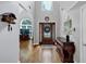 Elegant foyer with hardwood floors, a high ceiling, an ornate cuckoo clock, and a decorative stained glass front door at 3535 Fairgreen Ct, Douglasville, GA 30135