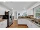 Bright kitchen features white cabinets, granite counters, stainless steel appliances and hardwood floors at 3535 Fairgreen Ct, Douglasville, GA 30135