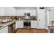 Well-organized kitchen with stainless steel appliances, granite countertops, white cabinetry, and hardwood floors at 3535 Fairgreen Ct, Douglasville, GA 30135