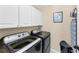 White cabinet laundry room equipped with washer and dryer at 3535 Fairgreen Ct, Douglasville, GA 30135