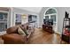Comfortable living room with a large window, hardwood flooring, modern decor, and stylish leather sofa at 3535 Fairgreen Ct, Douglasville, GA 30135