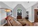 Bright living room features hardwood floors, a comfortable sofa, and a large arched window at 3535 Fairgreen Ct, Douglasville, GA 30135