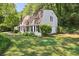 Exterior view of a single-Gathering home with manicured lawn, mature shade trees, and white siding at 4234 Long Branch Ct, Brookhaven, GA 30319