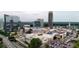 Aerial view of a shopping center with parking, roads, and other surrounding commercial and residential properties at 750 Park Ne Ave # 6E, Atlanta, GA 30326