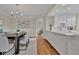 Dining room features hardwood floors, a chandelier and view of the open concept kitchen at 750 Park Ne Ave # 6E, Atlanta, GA 30326