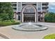 Luxurious building entrance with a water fountain and elegant architectural details at 750 Park Ne Ave # 6E, Atlanta, GA 30326
