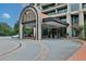 Upscale building entrance featuring a covered drop-off area and meticulous landscaping at 750 Park Ne Ave # 6E, Atlanta, GA 30326