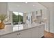 Bright kitchen features white cabinets, granite countertops, stainless steel appliances, and a breakfast nook with a view at 750 Park Ne Ave # 6E, Atlanta, GA 30326