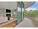 Bright living room extending to a balcony with a view of green trees at 750 Park Ne Ave # 6E, Atlanta, GA 30326