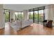 Bright living room with hardwood floors, a fireplace, and expansive windows, allowing for beautiful views at 750 Park Ne Ave # 6E, Atlanta, GA 30326
