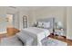Bright main bedroom with an upholstered headboard, bench seating, and wood floors offers a calm, comfortable space at 750 Park Ne Ave # 6E, Atlanta, GA 30326