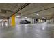 Spacious indoor parking garage featuring ample parking spaces and overhead lighting at 750 Park Ne Ave # 6E, Atlanta, GA 30326