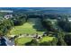 Aerial view of golf course surrounded by dense trees, showcasing the expansive and scenic layout at 8370 Royal Melbourne Way, Duluth, GA 30097
