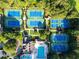 An aerial view of community tennis courts and pool surrounded by trees at 8370 Royal Melbourne Way, Duluth, GA 30097