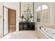 Elegant bathroom with custom vanities, soaking tub, walk-in shower, and modern fixtures at 8370 Royal Melbourne Way, Duluth, GA 30097