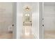 Hallway view to the bathroom with steam bath and walk-in closets at 8370 Royal Melbourne Way, Duluth, GA 30097