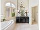 Luxurious bathroom features a soaking tub, custom vanity, and elegant fixtures for a spa-like experience at 8370 Royal Melbourne Way, Duluth, GA 30097