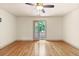 Bright bedroom with hardwood floors and walkout deck overlooking the yard at 8370 Royal Melbourne Way, Duluth, GA 30097
