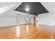 View of a spacious bedroom with a hardwood floor, white walls, and a dark painted inset ceiling at 8370 Royal Melbourne Way, Duluth, GA 30097