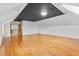 View of an empty bedroom with hardwood floors, white walls, and a dark painted inset ceiling at 8370 Royal Melbourne Way, Duluth, GA 30097