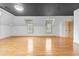 Bright bedroom featuring hardwood floors, windows, neutral walls, and a black accent ceiling at 8370 Royal Melbourne Way, Duluth, GA 30097