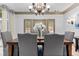Dining room with chandelier, doors to the outside, and seating for six at 8370 Royal Melbourne Way, Duluth, GA 30097