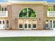 Beautiful home exterior featuring brick facade, large windows, and a spacious patio for outdoor living at 8370 Royal Melbourne Way, Duluth, GA 30097