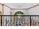 Grand foyer with wrought iron railing overlooking the living room with large windows and abundant natural light at 8370 Royal Melbourne Way, Duluth, GA 30097