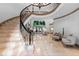 Grand foyer with marble floors, a curved staircase, and a view into the elegant living room at 8370 Royal Melbourne Way, Duluth, GA 30097