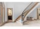 Elegant foyer featuring a curved staircase with marble steps and stylish decor at 8370 Royal Melbourne Way, Duluth, GA 30097
