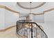 Grand foyer features a wrought iron staircase and elegant chandelier at 8370 Royal Melbourne Way, Duluth, GA 30097