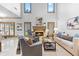 Living room with fireplace and tall windows allowing for lots of natural light at 8370 Royal Melbourne Way, Duluth, GA 30097