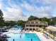 View of a beautiful community pool area with lounge chairs, umbrellas, and a slide at 8370 Royal Melbourne Way, Duluth, GA 30097