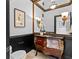 Ornate powder room featuring a decorative vanity, stylish lighting, and elegant finishes at 8370 Royal Melbourne Way, Duluth, GA 30097