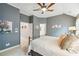 Comfortable bedroom featuring a decorative bed frame, ceiling fan, and natural light at 11259 Calypso Dr, Alpharetta, GA 30009