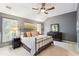 Comfortable bedroom featuring a decorative bed frame, ceiling fan, and natural light at 11259 Calypso Dr, Alpharetta, GA 30009